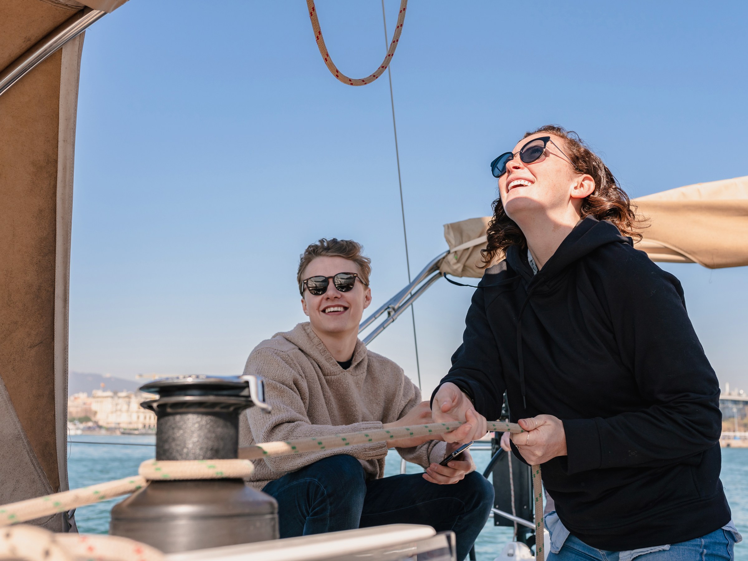 Happy people joining for a sail on the coast of barcelona