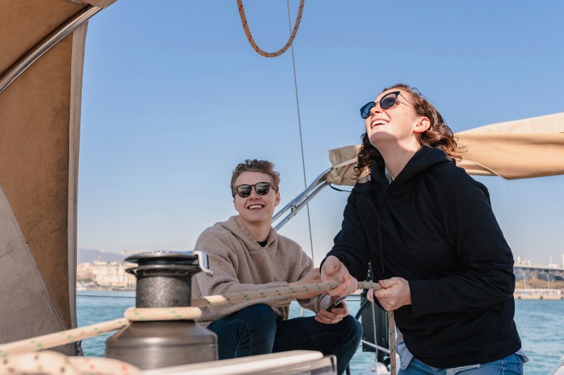 Happy people joining for a sail on the coast of barcelona