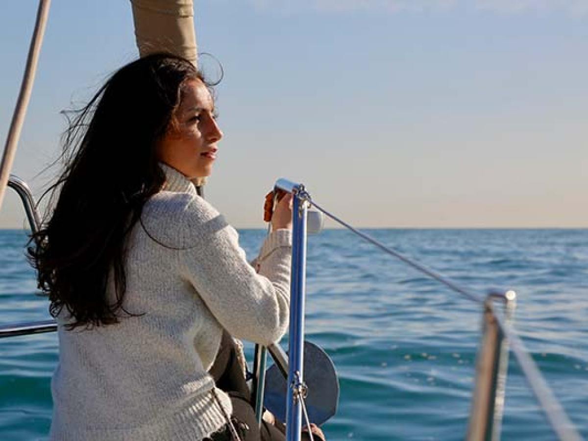 a woman standing next to a body of water