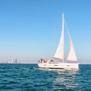 sailing yacht with barcelona skyline on the background