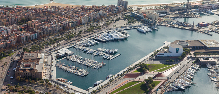 Marina Port Vell a harbor filled with water and a city in the background