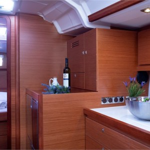 a kitchen with wooden cabinets and a vase of flowers on a table
